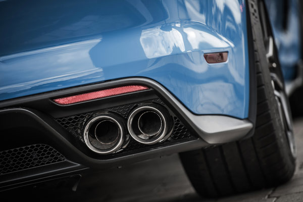 Close up of twin exhaust on a blue car.
